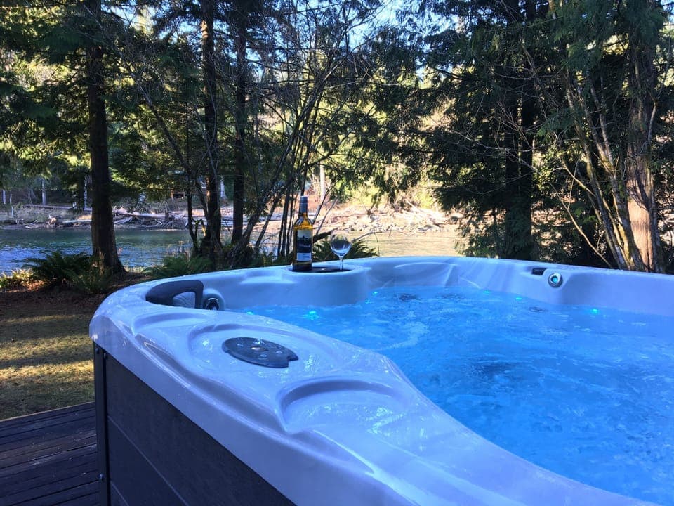 Relaxing in the hot tub by the river—pure mountain bliss.
