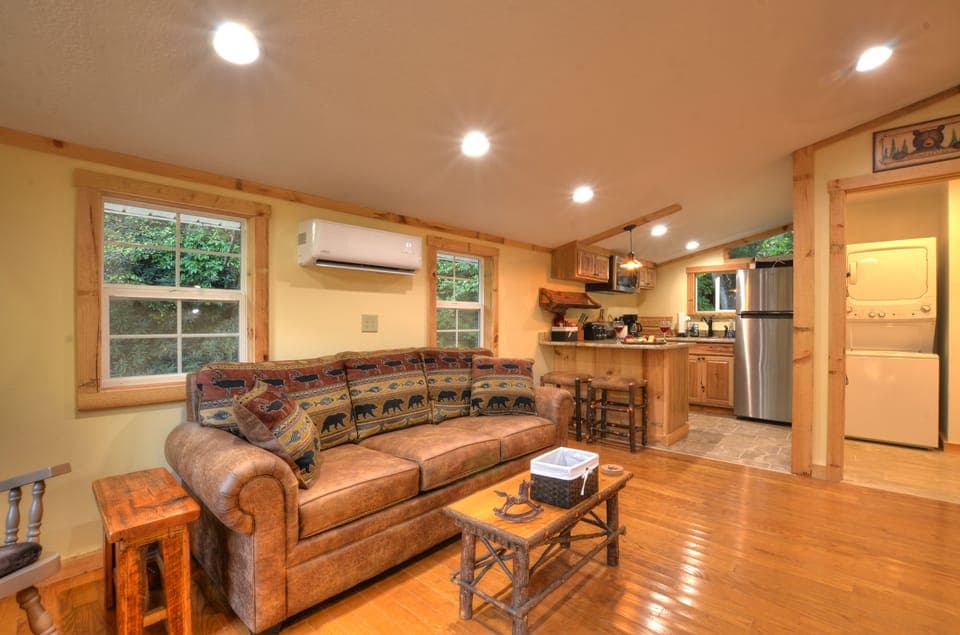Open living area connects cozy seating and full kitchen.