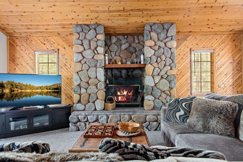 Upstairs Living room with a wood burning fireplace, 55" Smart TV, and games