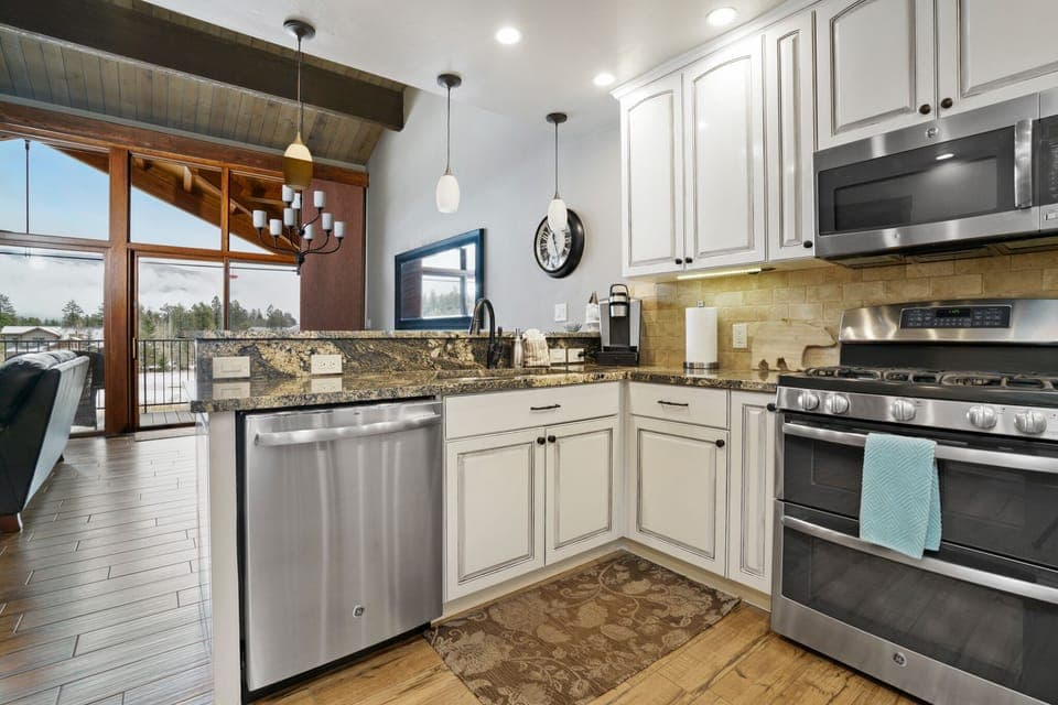 Kitchen opens up to living and dining area with picturesque view