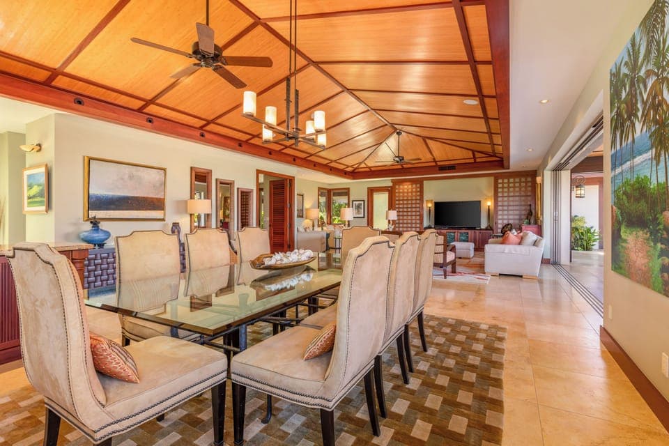 Enjoy tropical meals in this formal dining room with seamless access to both kitchen and outdoor spaces.