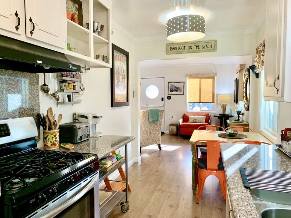 View from kitchen into living room.   Lots of light with many windows. 
