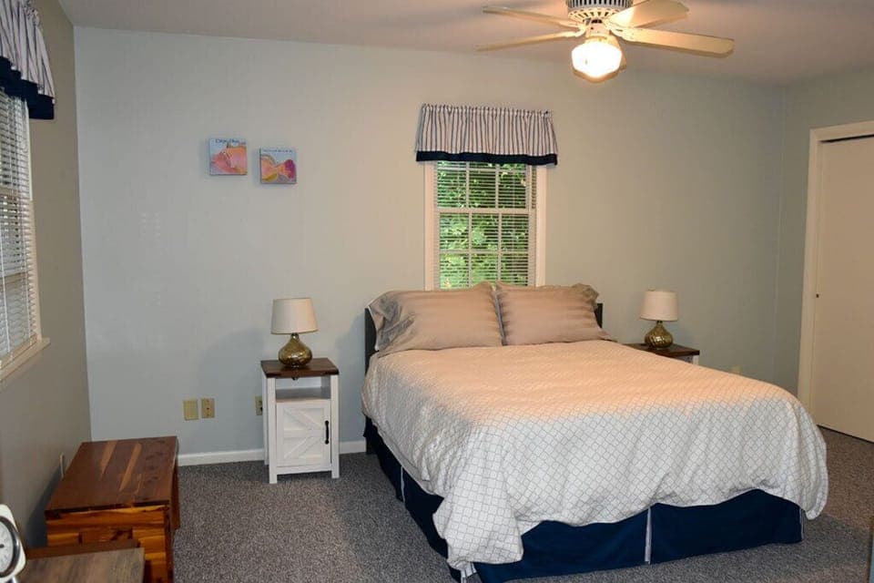 Queen size bed. End tables contain phone charges and electrical connections.