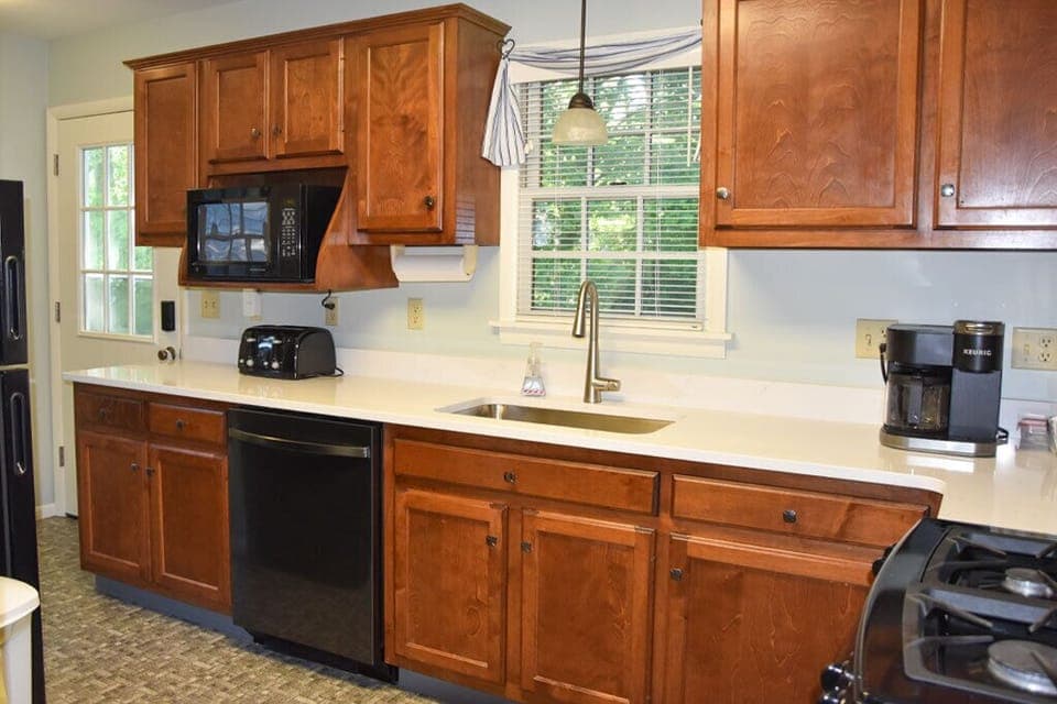 Full kitchen; quartz counters, microwave, dishwasher, and Keurig coffee maker.