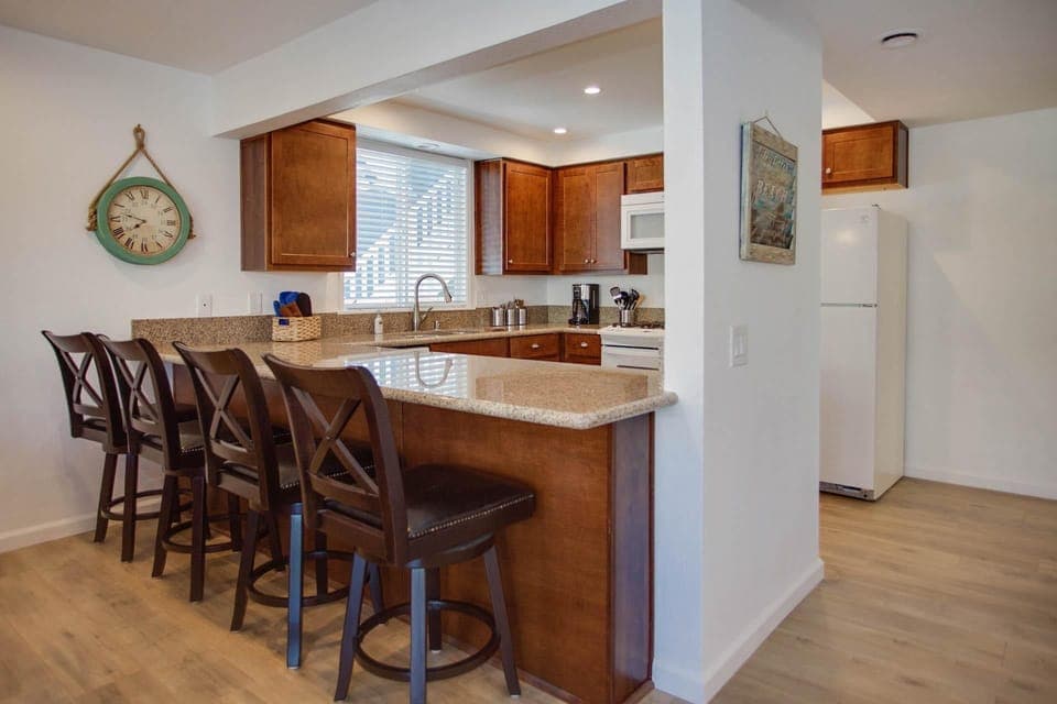 Breakfast bar seating overlooks kitchen headquarters.
                