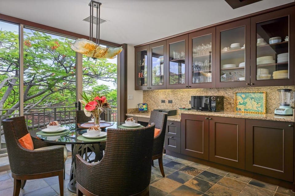 Casual dining space surrounded by windows and greenery—ideal for laid-back meals or coffee breaks.