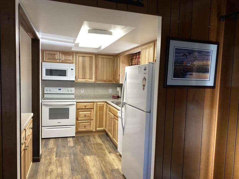 Kitchen off of the dining room. Coffee pot,microwave,dishwasher,stove & fridge. 