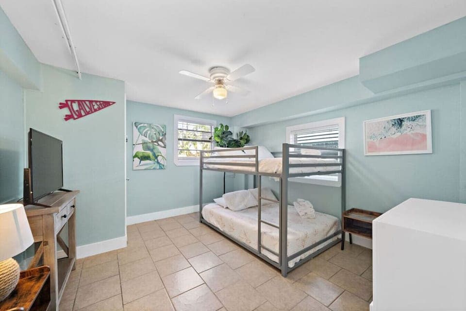 Cozy up in this bedroom featuring a full bunk bed, providing comfort and convenience, along with a smart TV for entertainment