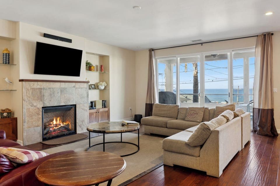 Perfect gathering area for friends and family in front of fire with ocean view.