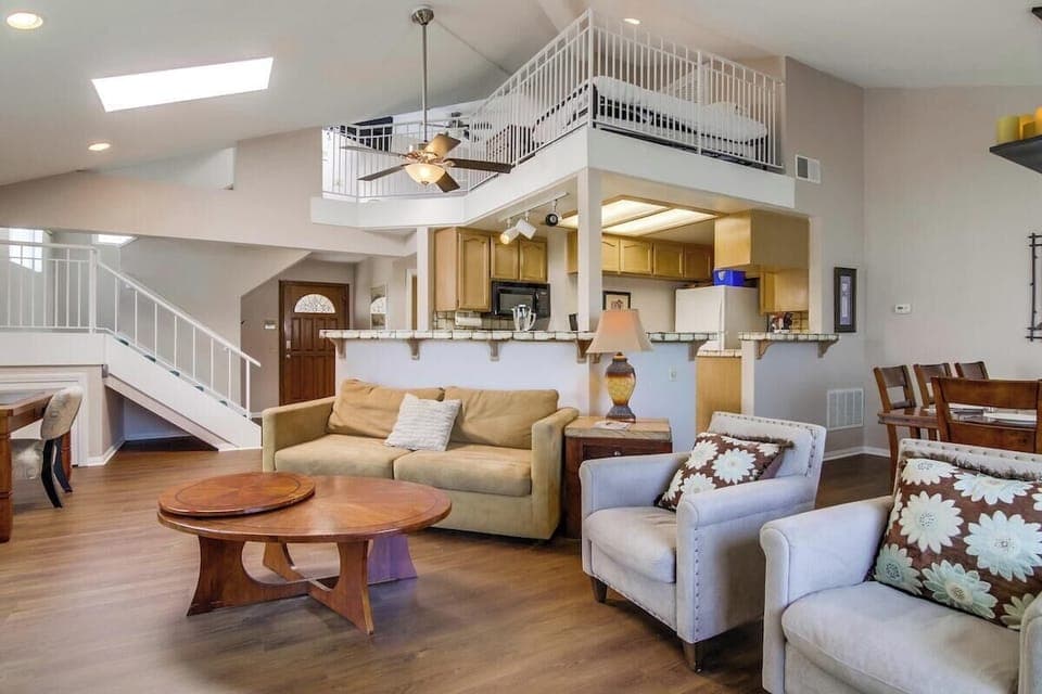 Front entrance to living room, dining room, kitchen in between, and loft shown above