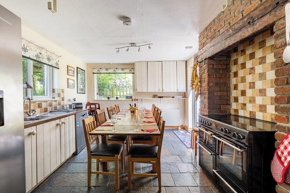 The farmhouse kitchen has a ten seater dining table,  range cooker and American fridge freezer.   The separate utility room has ample hanging space for outdoor coats, washing machine, tumble dryer and drinks fridge plus an adjoining shower room/loo.