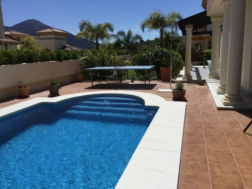 View over the pool , table tennis table, garden and veranda around the house