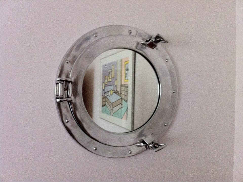 Port hole mirror in middle floor back bedroom.