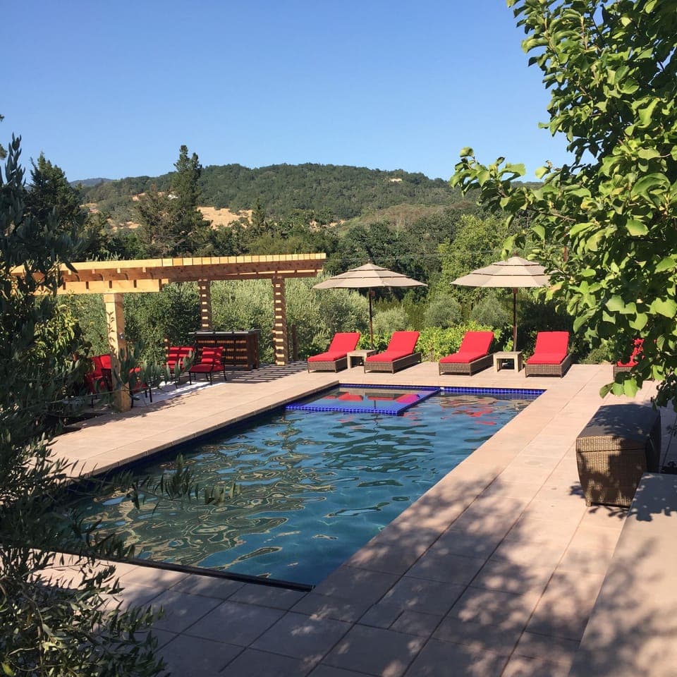 Beautiful pool, hot tub, bar, seating area with room for  all.