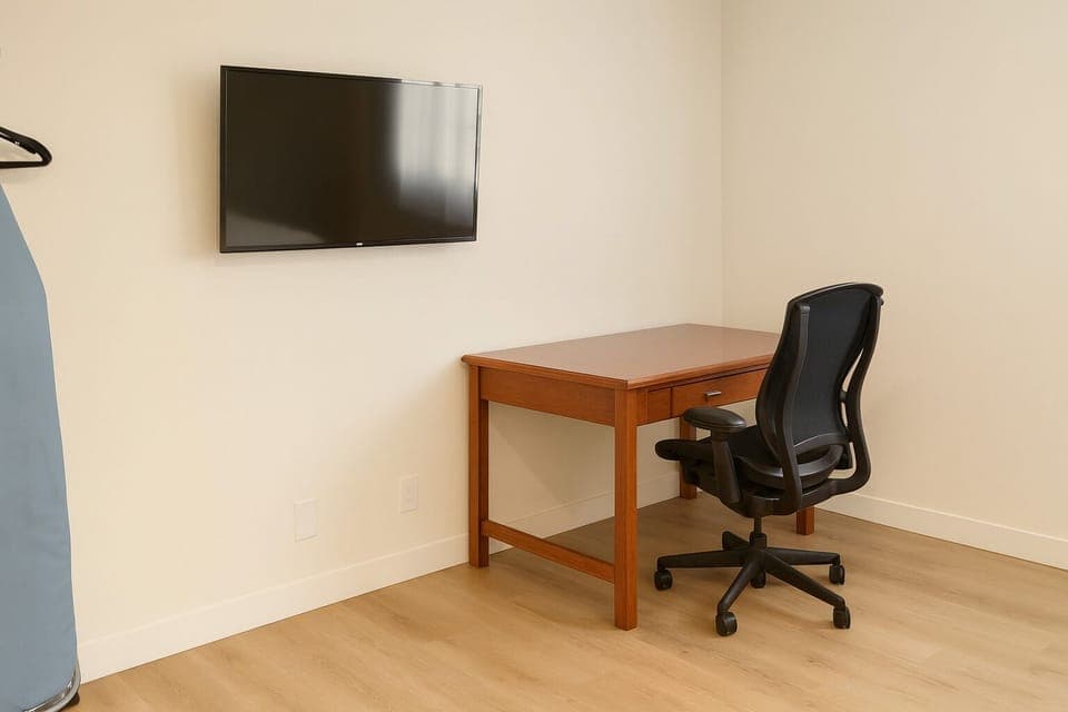 Premium bedding, desk, laptop workspace, blackout drapes