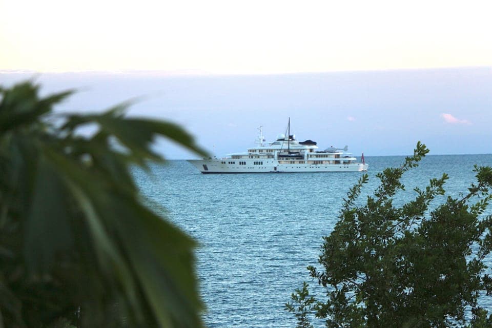 Private Yacht with Helicopter visiting Placencia. At anchor off of our dock.
