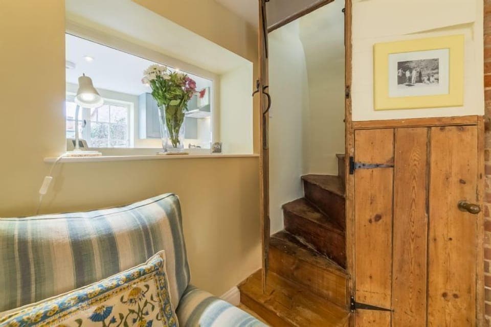 Ground floor: Sitting room with Norfolk winder stairs leading to the first floor