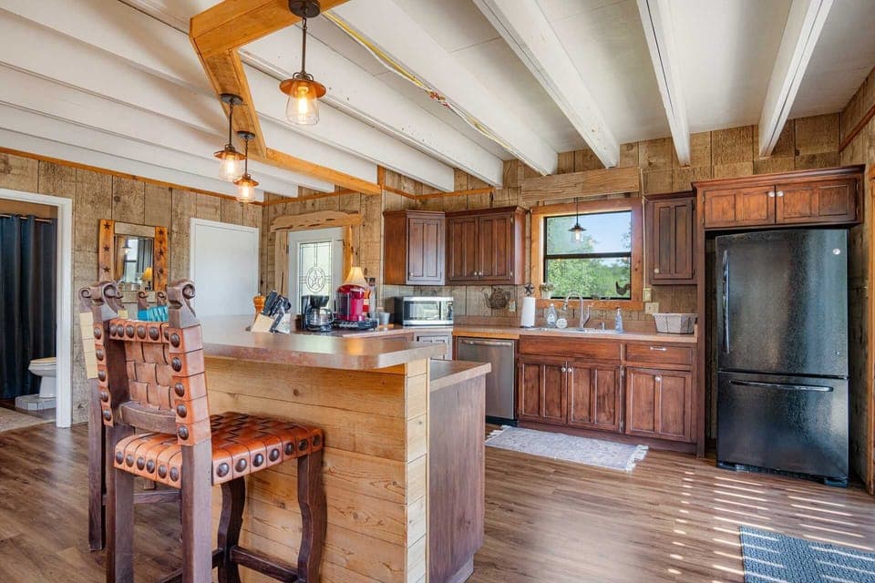 "Whip up delicious meals in this fully equipped, charming kitchen with a rustic touch."