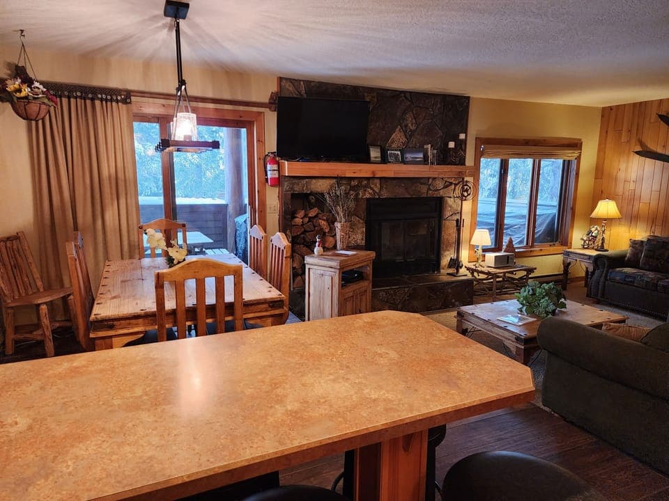 Dining and living room with TV/DVD, pull out couch, loveseat, radio, & fireplace