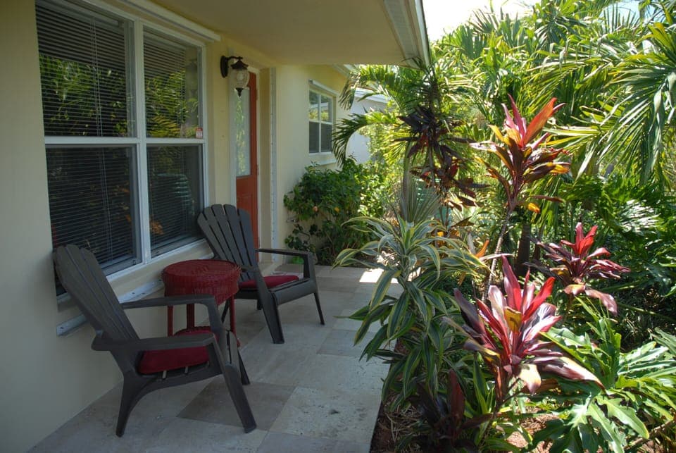 Relax on covered front porch with cascading water fountain & wind chimes.