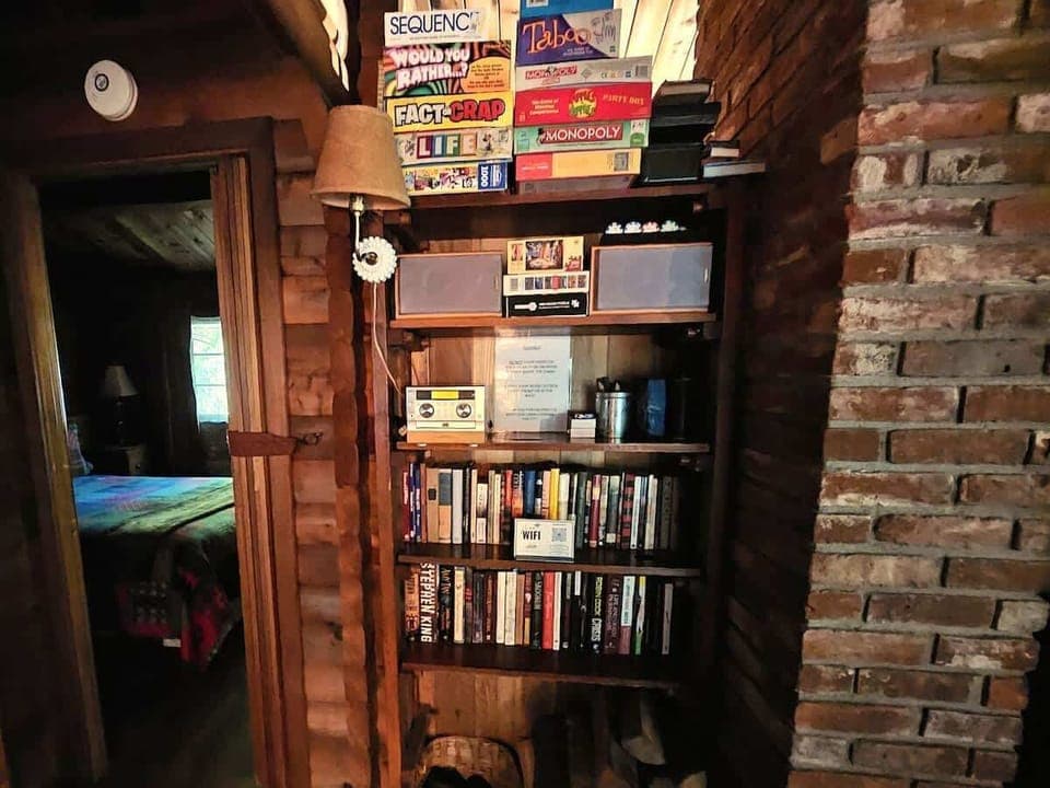 Sorry, no TV's!   Enjoy the CD collection, boardgames or choose 1 of many books within the cabin to read.