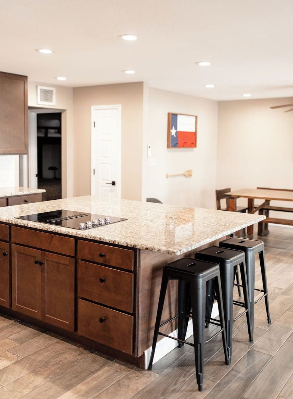 Open kitchen with large island and farm table