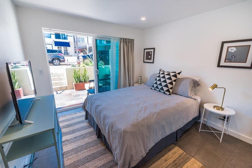 Lower level bedroom provides Queen bed, linens, Roku TV, closet, sliding glass door out to front sub-street patio and seating.
                