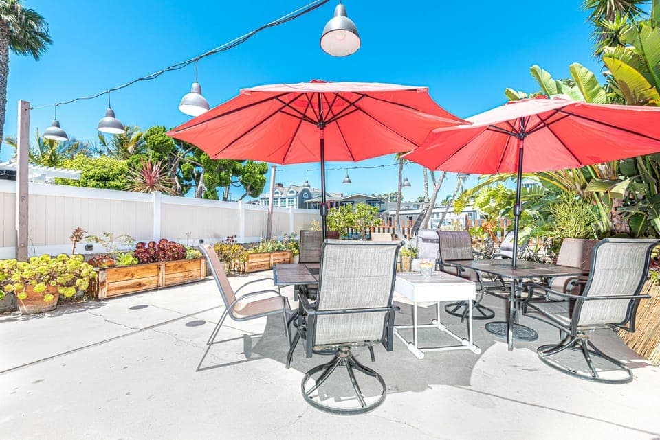 This two-story, single-family home is tucked away in its own bayside garden oasis on one of Newport Harbor’s side channels.
                