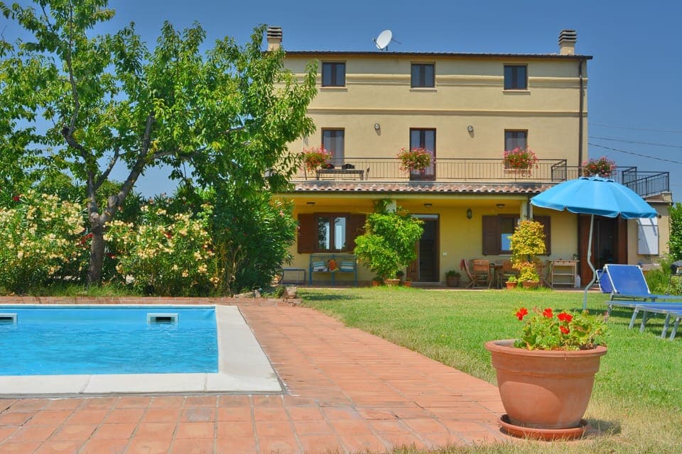 A 4 bedroom house with a private garden with a pool & parking area