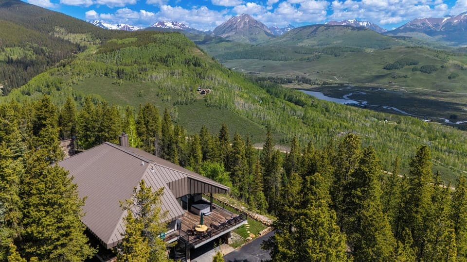 Aerial of the house and wrap around deck with 40+ miles of panoramic visibility