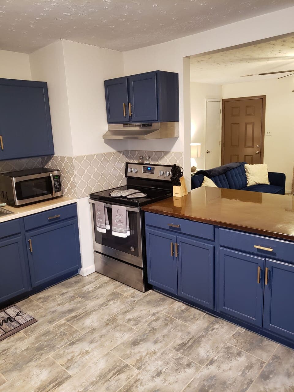 Full size refrigerator in kitchen. There is also a dishwasher.