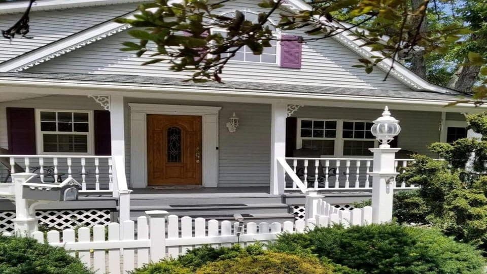Lambs Landing front porch, dual glide rocker, two swivel chairs and side tables.