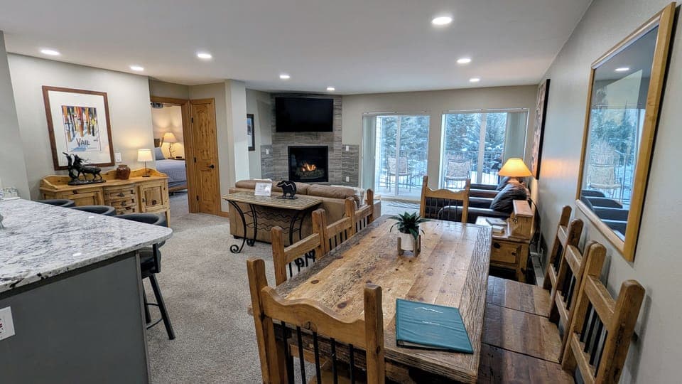 Living room with sofa bed, gas fireplace, and balcony w/ propane BBQ grill