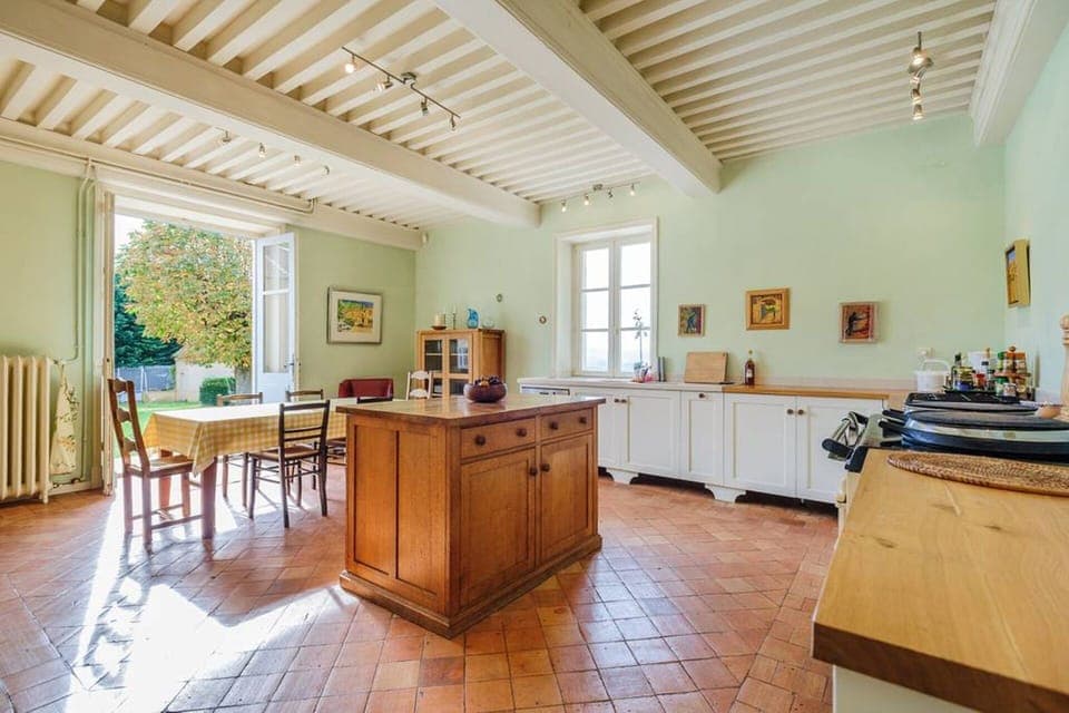 Sunny kitchen, tiled floor, bespoke oak unit, aga, gas hob and electric oven