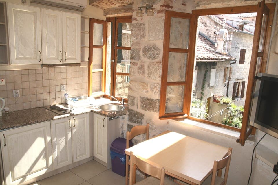 Airy with two windows, kitchenette plus  table & chairs.