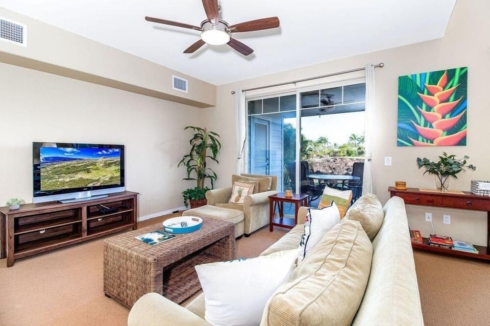 Light living room with sliding doors opening to a breezy lanai.