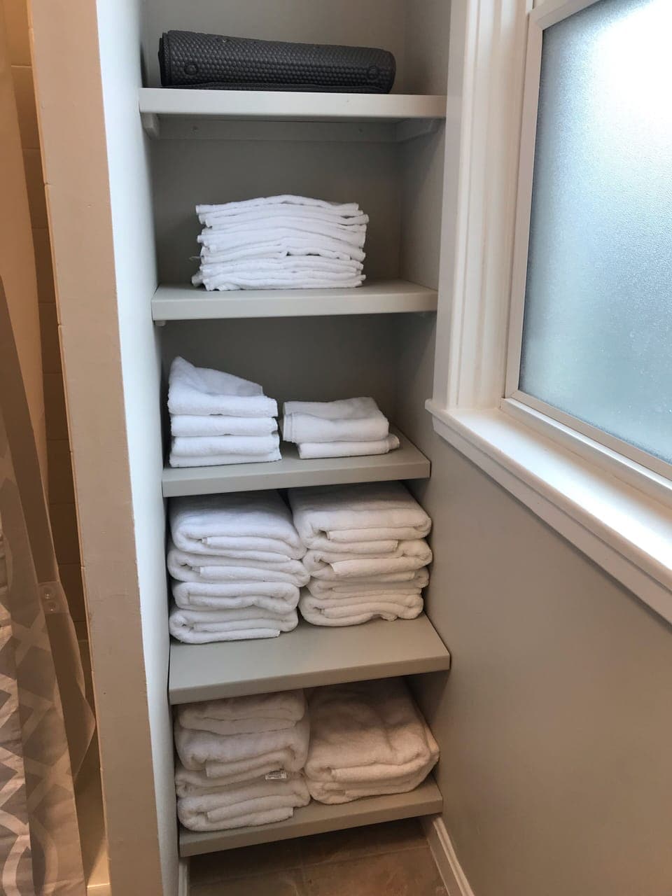 Second floor full bath with plenty of linens and a hair dryer.