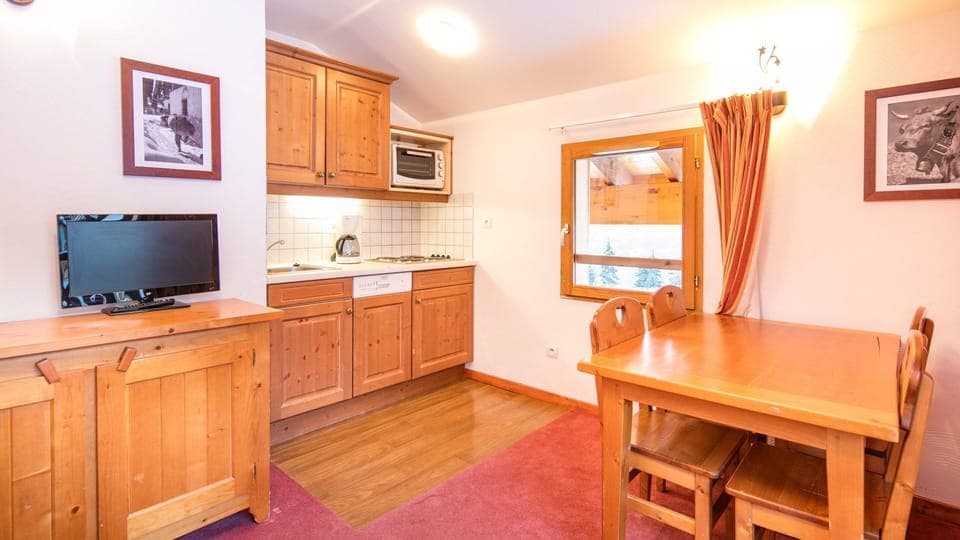 Prepare meals in the kitchenette and enjoy them at the dining table.