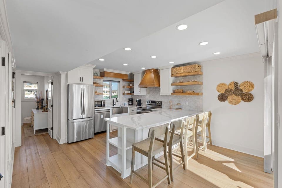 Your bright, open kitchen welcomes you with warm wood accents, marble countertops, and everything needed for memorable meals together.