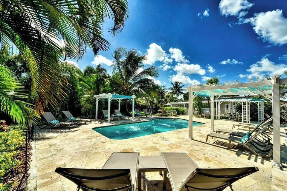 Pool has shaded and sunny areas with lounge chairs.