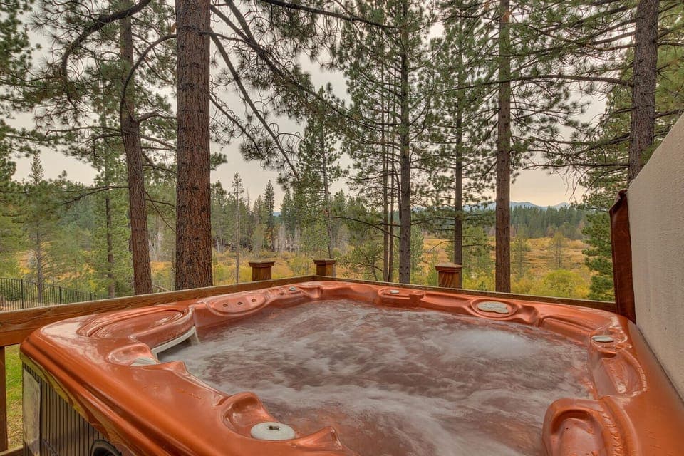 - Outdoor hot tub with forest views  
- Relaxing spa retreat under tall pines  
- Mountain getaway with bubbling jacuzzi