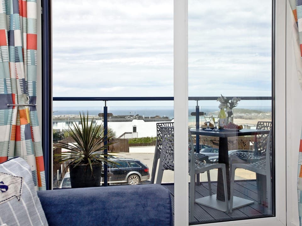 Living area with sliding doors to the balcony | Fistral Escape - Ocean 1 Apartments, Newquay