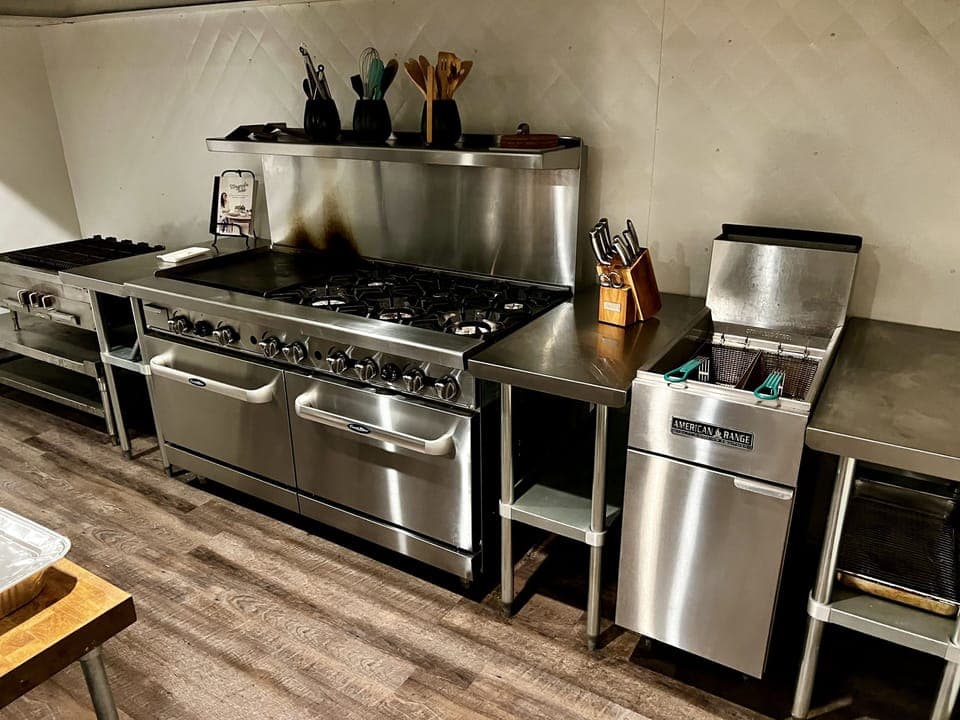 Commercial kitchen. Gas range with two ovens, 6 burners, and 24" griddle