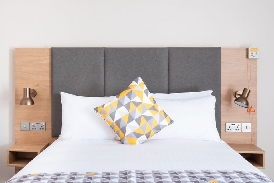 Hypo-allergenic bedding, desk, laptop workspace, blackout drapes