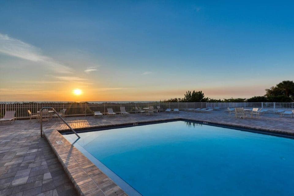Sunset reflections shimmer across the pool, creating a peaceful spot to unwind as the day fades.