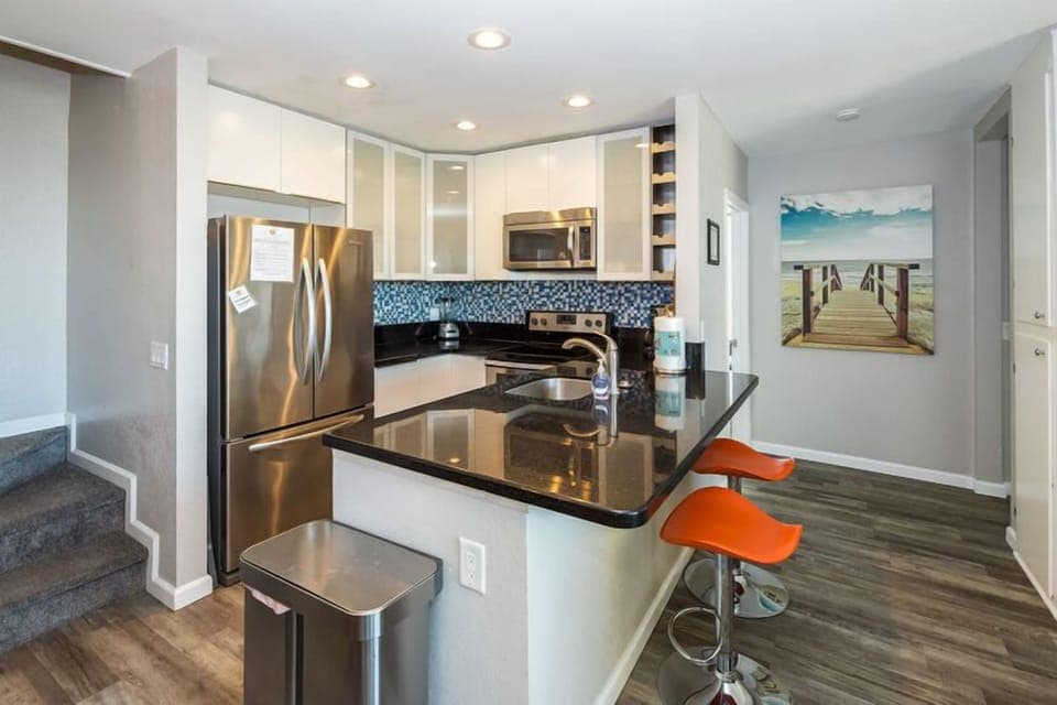 Fully stocked kitchen features all stainless steal appliances