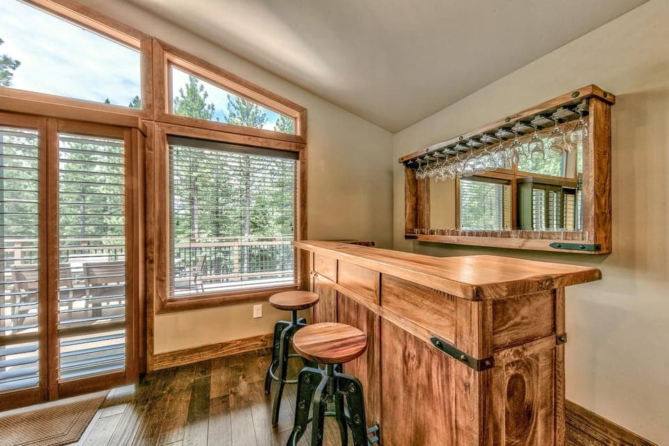 Cozy home bar with forest views and natural light