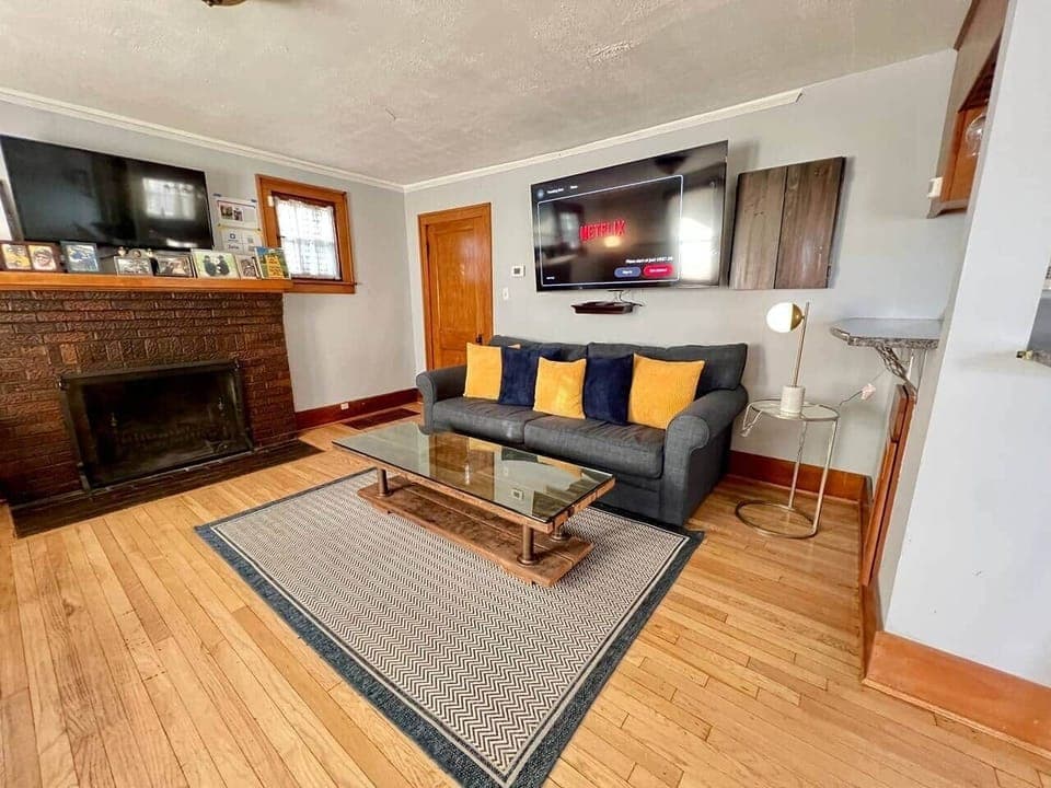 Living room features two flat screen TVs