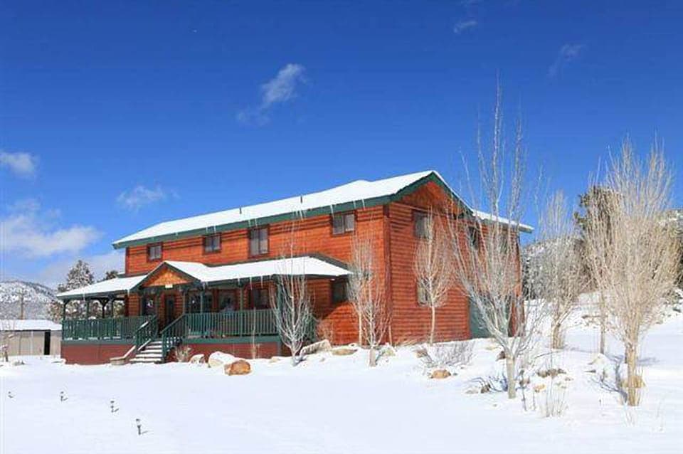 Snow covered Big Bear Cool Cabins, Bear Family Ranch front