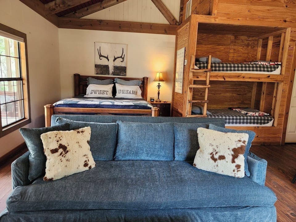 Open floor plan with king bed and bunk beds